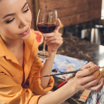 A Woman Holding A Glass Of Wine