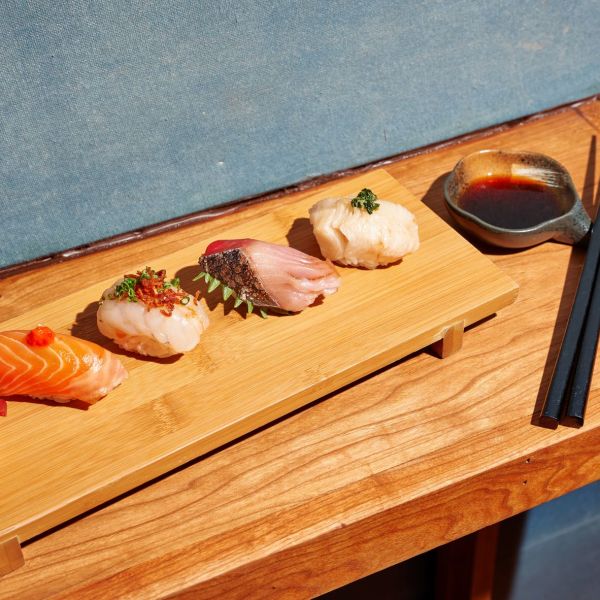 A Wooden Cutting Board With Sushi